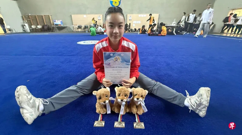 Cholene Aw showing her achievement on the Wushu floor